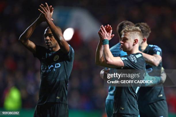 Manchester City's Brazilian midfielder Fernandinho and Manchester City's Ukrainian midfielder Oleksandr Zinchenko applaud supporters on the pitch as...
