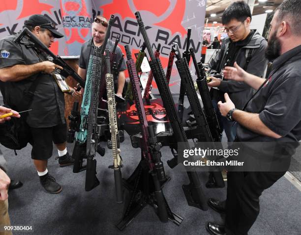 Convention attendees look at rifles at the Black Rain Ordnance booth at the 2018 National Shooting Sports Foundation's Shooting, Hunting, Outdoor...
