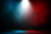 Spotlight fight and match red and blue smoke background.
