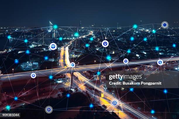 city at night with communication icons and network lines mix media concept background - sentier skyline photos et images de collection