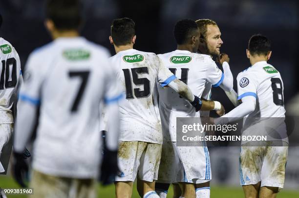 Olympique de Marseille's French forward Valere Germain is congratulated by teammates after scoring a goal during the French Cup football match...