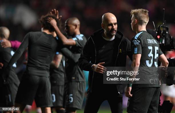 Manchester City manager Pep Guardiola congratulates Oleksandr Zinchenko after the Carabao Cup Semi-Final: Second Leg match between Bristol City and...