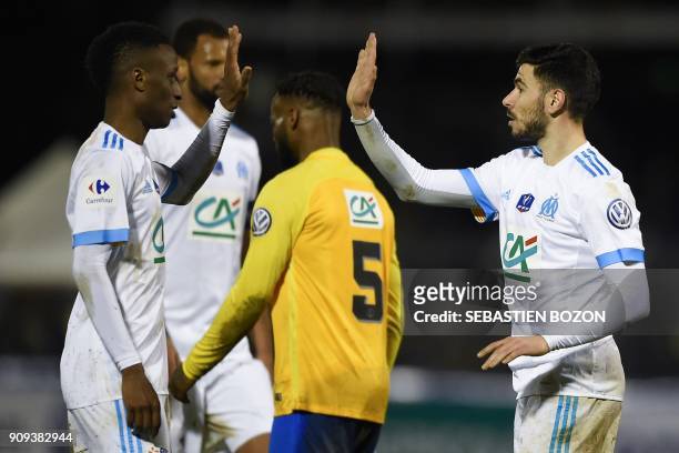 Olympique de Marseille's French midfielder Morgan Sanson is congratulated by teammates after scoring a goal during the French Cup football match...