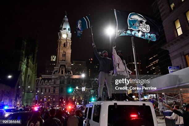 Naveet Singh and Gurvinder Singh, both brothers from Middlesex County, New Jersey, wave Eagles flags while stopped in traffic on North Broad Street...