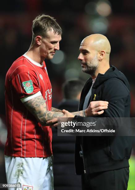 Josep Guardiola manager of Manchester City with Aden Flint of Bristol Cityduring the Carabao Cup Semi-Final 2nd leg match between Bristol City and...
