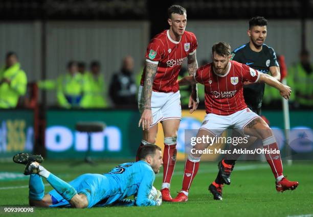 Luke Steele Aden Flint and Nathan Baker of Bristol City combine to hold off Sergio Aguero of Manchester City during the Carabao Cup Semi-Final 2nd...