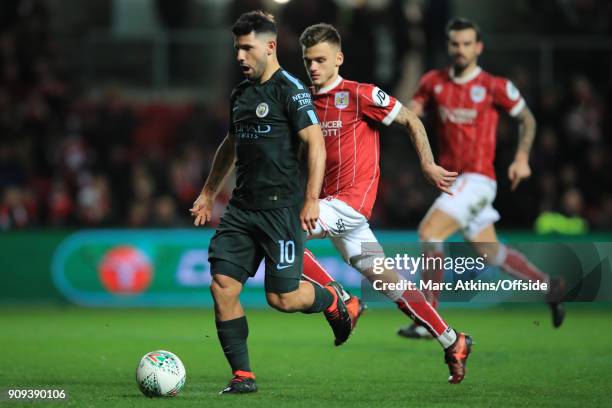 Sergio Aguero of Manchester City in action with Jamie Paterson of Bristol City during the Carabao Cup Semi-Final 2nd leg match between Bristol City...