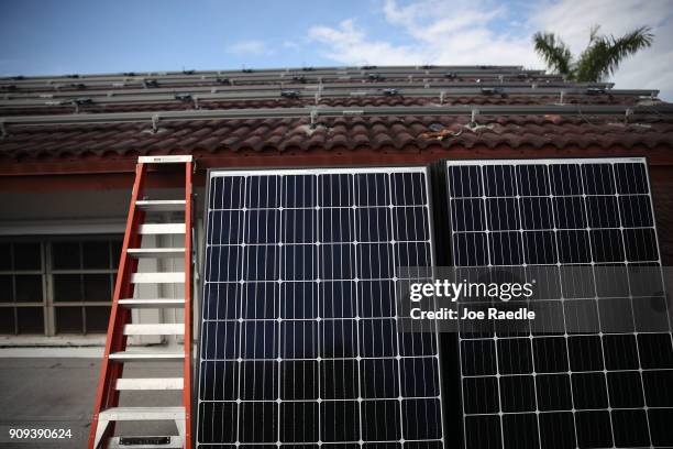 Solar panels are seen stacked against the wall as the Goldin Solar company installs the solar panel system on the roof of a home a day after the...