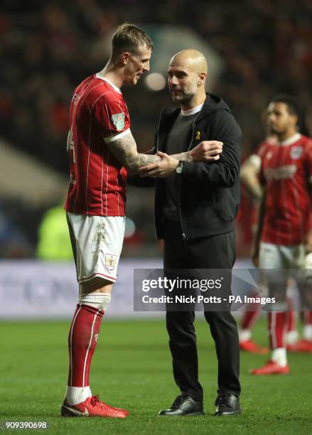 Bristol City's Aden Flint and Manchester City manager Pep Guardiola after the Carabao Cup semi final, second leg match at Ashton Gate, Bristol.