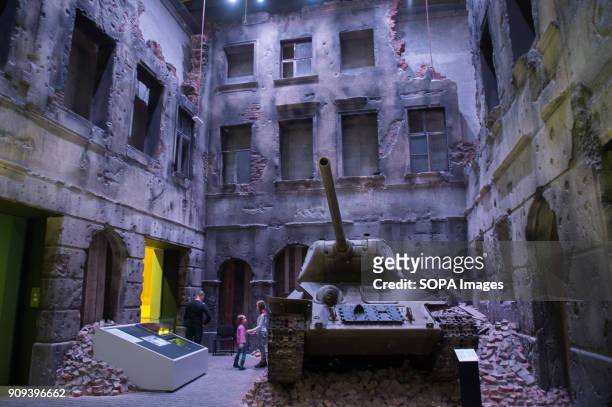 Visitors walk inside a recreation war scene in one of the exhibit rooms at the World War 2 Museum. The world war 2 museum in the Polish city of...
