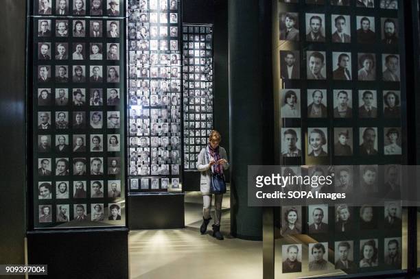 Visitors look at a mural with pictures of jewish victims in one of the exhibit rooms at the World War 2 Museum. The world war 2 museum in the Polish...