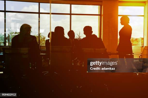 working long hours - silhouette meeting stock pictures, royalty-free photos & images