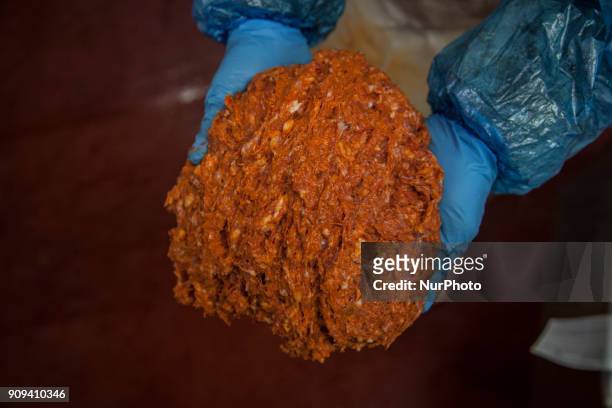 An operator of one of the chacineras factories in the county town of Noreña shows the pork once chopped to proceed to stuff it and smoke it in Noreña...