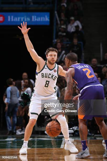 Isaiah Canaan of the Phoenix Suns handles the ball against Matthew Dellavedova of the Milwaukee Bucks during the game between the two teams on...