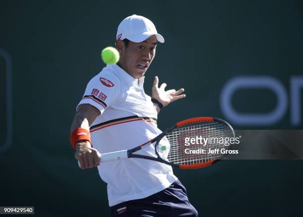 Kei Nishikori of Japan returns a backhand volley to Dennis Novikov during the first round of the Oracle Challenger Series at the Newport Beach Tennis...