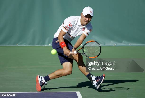 Kei Nishikori of Japan lunges to return a backhand to Dennis Novikov during the first round of the Oracle Challenger Series at the Newport Beach...