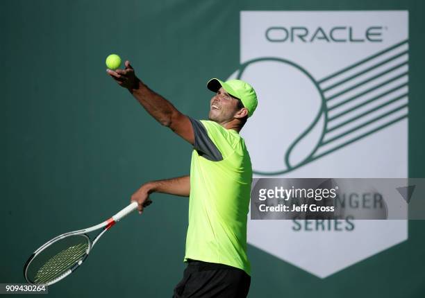 Dennis Novikov tosses the ball up before serving to Kei Nishikori of Japan during the first round of the Oracle Challenger Series at the Newport...