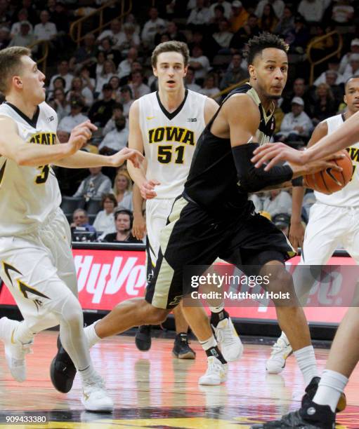 Forward Vincent Edwards of the Purdue Boilermakers drives to the basket during the second half in front of guard Jordan Bohannon and forward Nicholas...