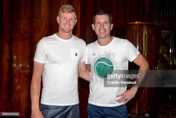 In this handout provided by Tennis Australia, Kyle Edmund of Great Britain poses with Tim Henman during day 10 of the 2018 Australian Open on January...