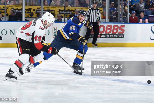 Alexander Steen of the St. Louis Blues and Christopher DiDomenico of the Ottawa Senators look for control of the puck at Scottrade Center on January...