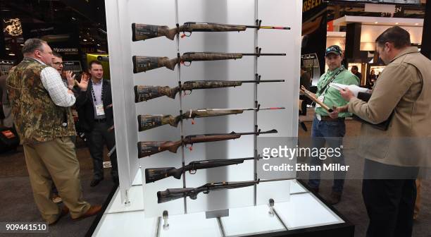 Convention attendees look at rifles at the Browning booth at the 2018 National Shooting Sports Foundation's Shooting, Hunting, Outdoor Trade Show at...