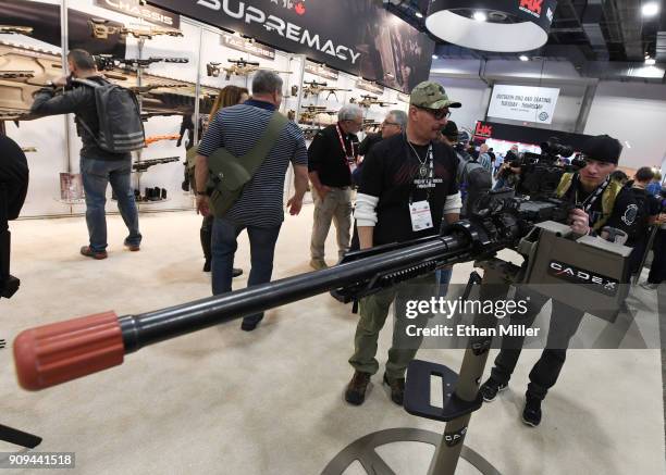 Mother of all Rucks Foundation members Ralph Cook of Nevada and Kenneth Conkright of Colorado look at a .50 caliber M2 machine gun equipped with a...