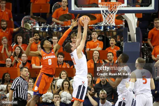 Ty Jerome of the Virginia Cavaliers rebounds in front of Clyde Trapp of the Clemson Tigers in the second half during a game at John Paul Jones Arena...