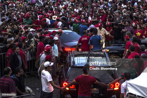 Demonstrators surround a motorcade carrying former President Luiz Inacio Lula da Silva during a rally in support of him ahead of his appeal hearing...