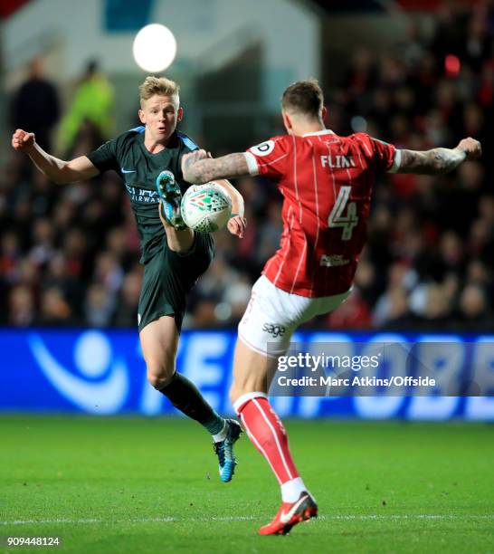 Aden Flint of Bristol City in action with Oleksandr Zinchenko of Manchester City during the Carabao Cup Semi-Final 2nd leg match between Bristol City...