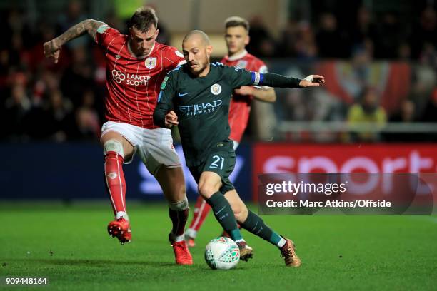 David Silva of Manchester City in action with Aden Flint of Bristol City during the Carabao Cup Semi-Final 2nd leg match between Bristol City and...