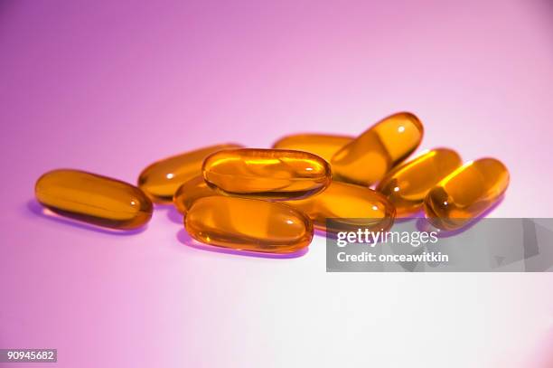 fish oil capsules - cod liver oil stock pictures, royalty-free photos & images