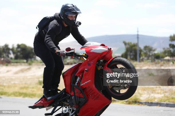 biker riders - motorcycle stunt stock pictures, royalty-free photos & images