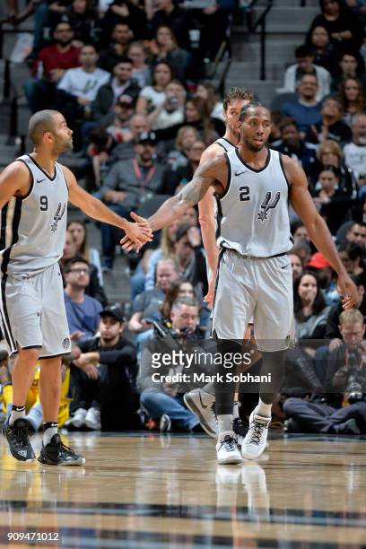 Tony Parker of the San Antonio Spurs and Kawhi Leonard of the San Antonio Spurs high five against the Denver Nuggets on January 13, 2018 at the AT&T...