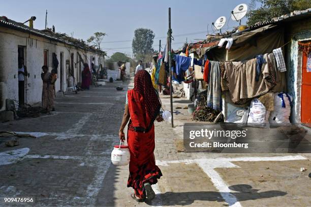 Worker walks past staff homes at the Sri Krishna Gaushala on the outskirts of New Delhi, India, on Sunday, Jan. 21, 2018. The nursing home offers...