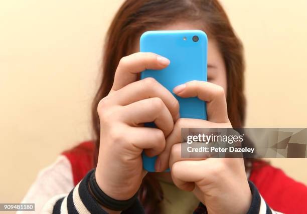 obsessive teenager texting on smart phone - obscured face stock pictures, royalty-free photos & images