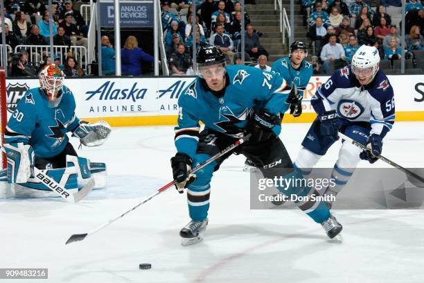 Aaron Dell of the San Jose Sharks protects the net as Dylan DeMelo of the San Jose Sharks keeps the puck away from Marko Dano of the Winnipeg Jets at...