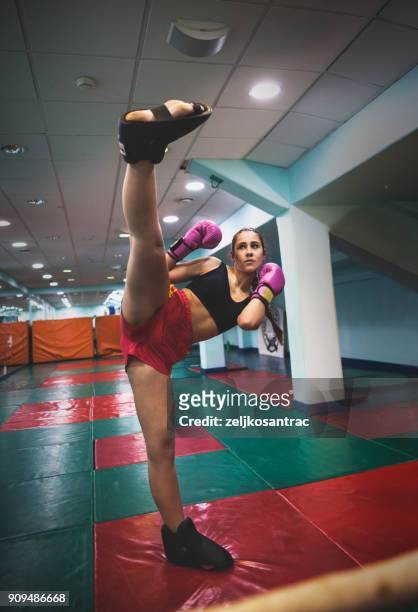 female kickboxer fighter training - girl kicking stock pictures, royalty-free photos & images