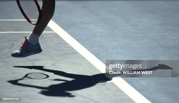 Romania's Simona Halep casts a shadow as she hits a return against Czech Republic's Karolina Pliskova during their women's singles quarter-finals...