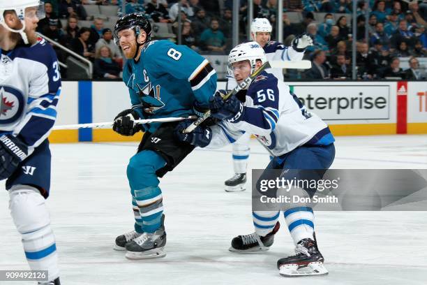 Marko Dano of the Winnipeg Jets defends Joe Pavelski of the San Jose Sharks at SAP Center on January 23, 2018 in San Jose, California.