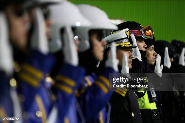 South Korean police officers salute during the inauguration ceremony for the designated special police battalion of the 2018 PyeongChang Winter...