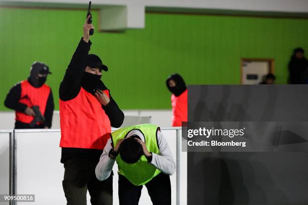 People participate in a simulated terrorism crisis drill in advance of the 2018 PyeongChang Winter Olympic Games in Pyeongchang, Gwangon, South...