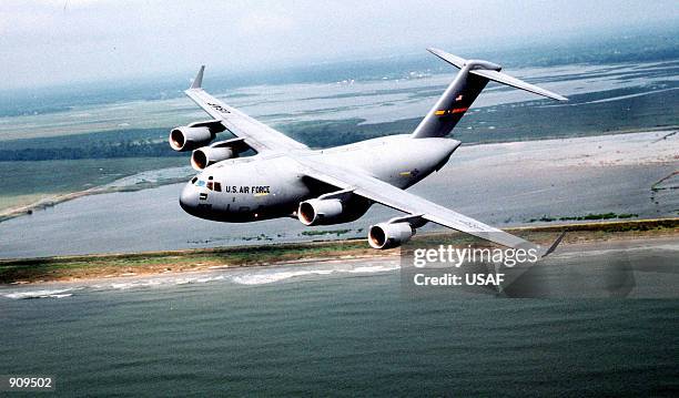 An air-to-air left side view of a C-17 Globemaster III from the 17th Airlift Squadron, 437th Air Wing, Charleston Air Force Base, South Carolina as...