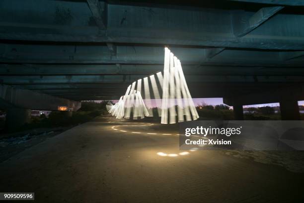 light rainbow swing in space - light painting stock-fotos und bilder