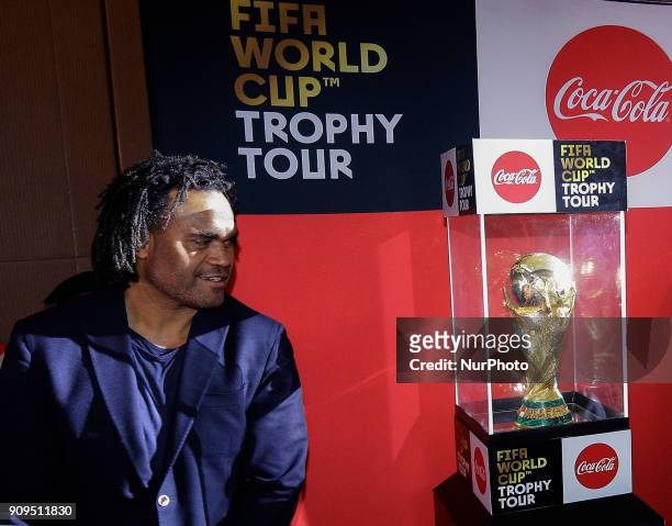 Christian Karembeu , a member of the French football team that won the 1998 World Cup looks at the 2018 FIFA World Cup Trophy after the official...