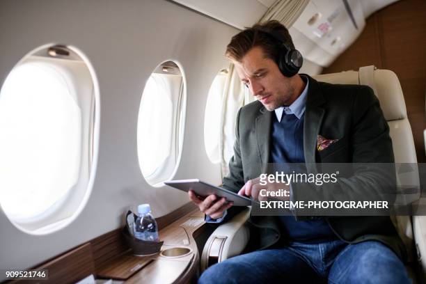 man in private jet airplane - extreme wealth stock pictures, royalty-free photos & images