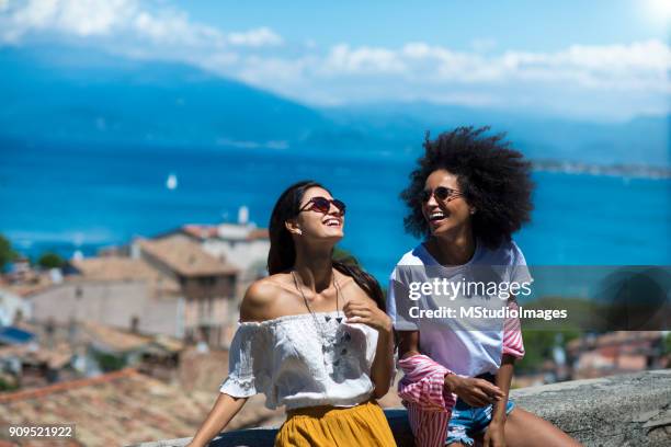 two happy woman friends laughing - europe summer stock pictures, royalty-free photos & images