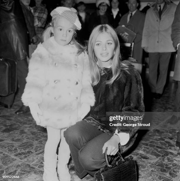 Swedish actress and singer Britt Ekland with her daugher Victoria Sellers at Heathrow Airport, 21st December 1968.