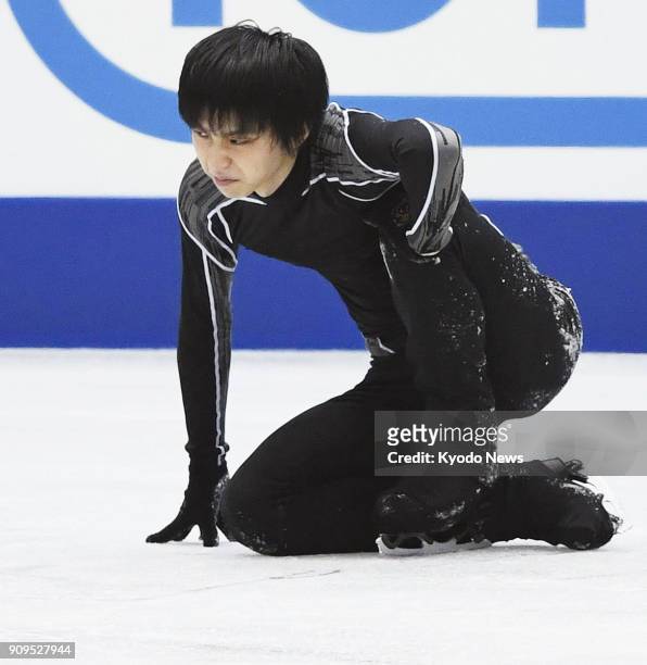 Japanese figure skater Yuzuru Hanyu winces after injuring his right leg in this file photo taken in November 2017, during practice for the NHK Trophy...