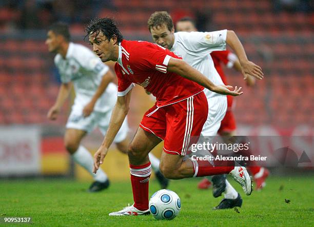 Luca Toni of Bayern Muenchen battles for the ball with Stefan Jarosch of Regensburg during the Third Liga match between Bayern Muenchen II and SSV...