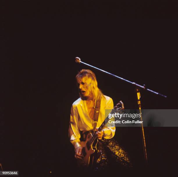 Mick Ronson performs on stage with David Bowie and the Spiders from Mars during the final night of the Ziggy Stardust tour at the Hammersmith Odeon...